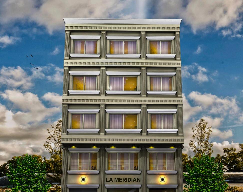 a tall building with many windows on it at Hotel La Meridian, A Four Star Luxury Hotel & Resort - Haridwar in Haridwār