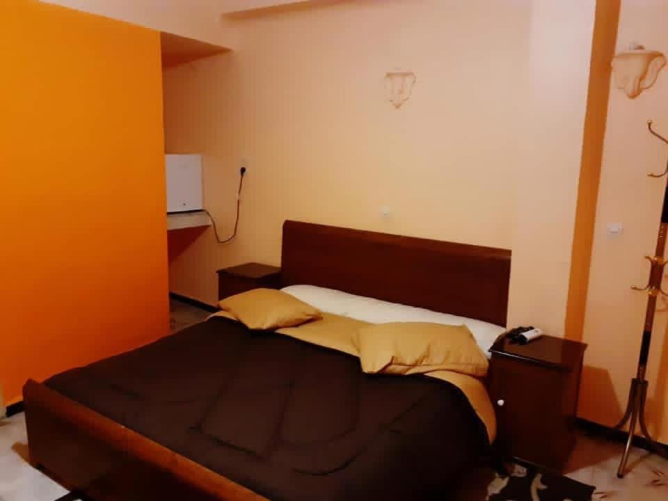 ein Schlafzimmer mit einem Bett in einem Zimmer in der Unterkunft Hotel el djawhara in Melika