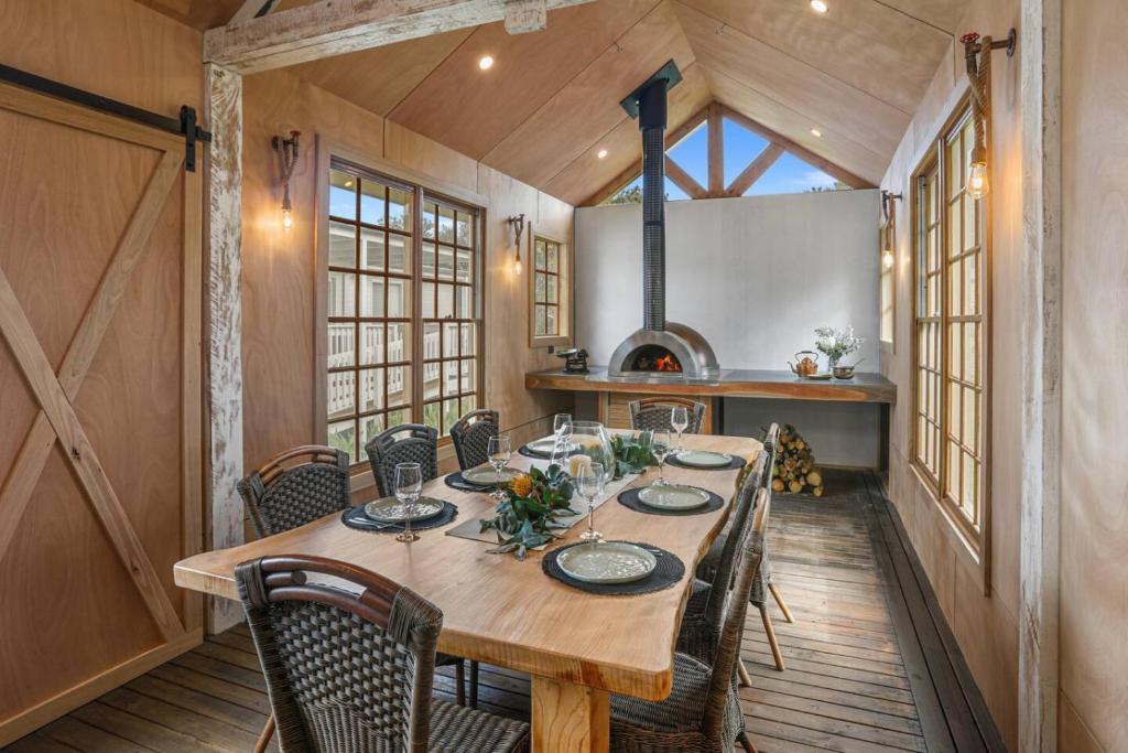 a dining room with a wooden table and chairs at Galbraith Beach Studio 1 - steps away from beach in Marengo