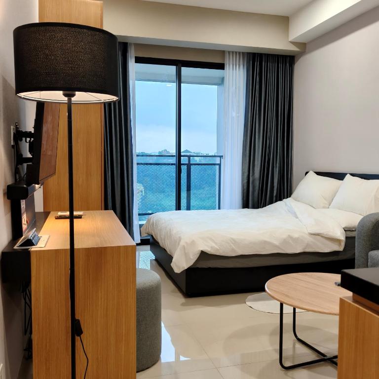 a hotel room with a bed and a window at Saffron Noble Apartment in Citaringgul 1