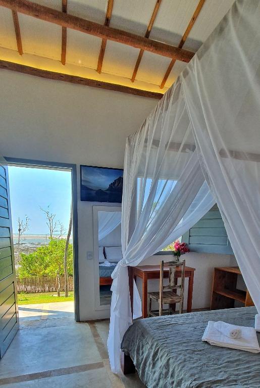 a bedroom with a bed and a view of the ocean at Casa Bella Guriú in Guriú