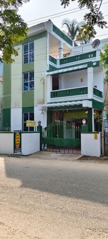 a green and white building with a bench in front of it at Le Green House Villa in Pondicherry