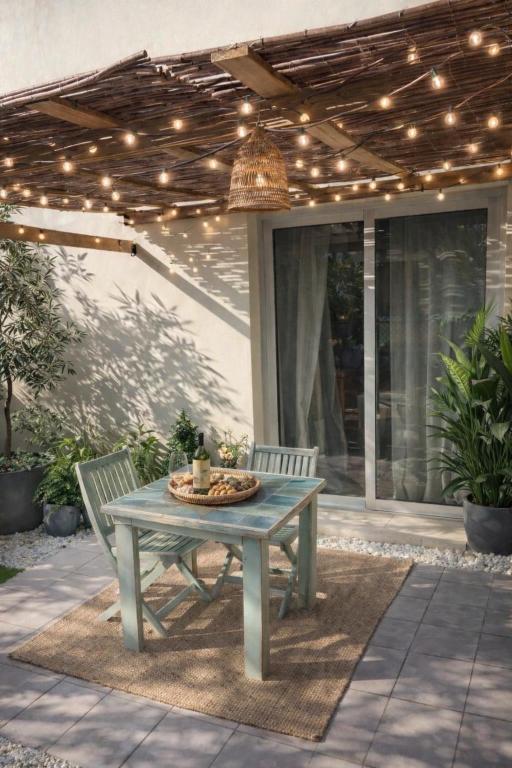 a table and two chairs on a patio with lights at casa kayla in Palm-Mar