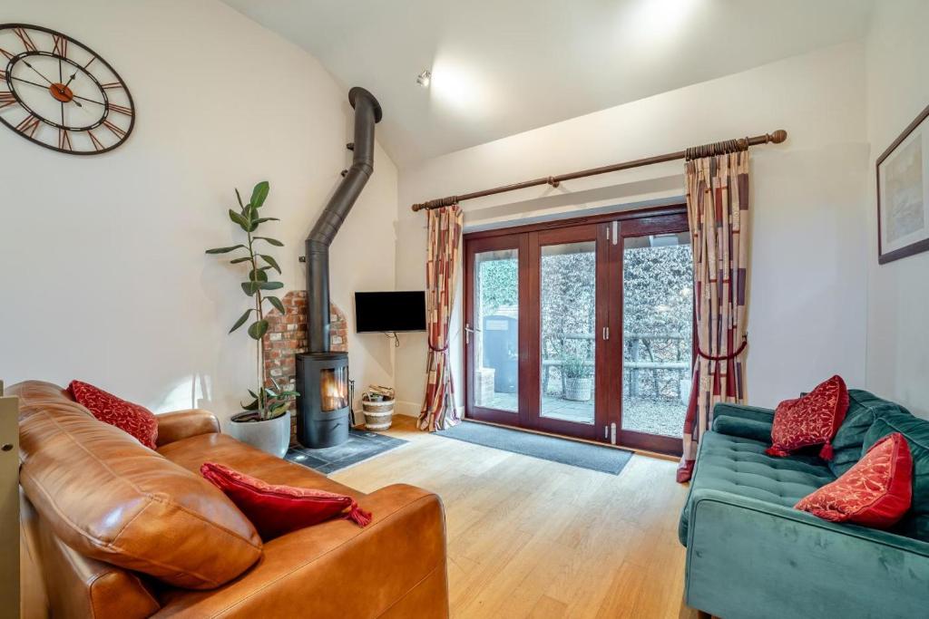 a living room with a couch and a clock on the wall at 2 Bed in Farnham oc-t34459 in Farnham