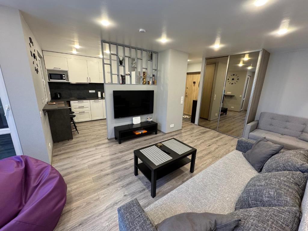 a living room with a couch and a table at Apartment near the sea-Sigulda street in Liepāja