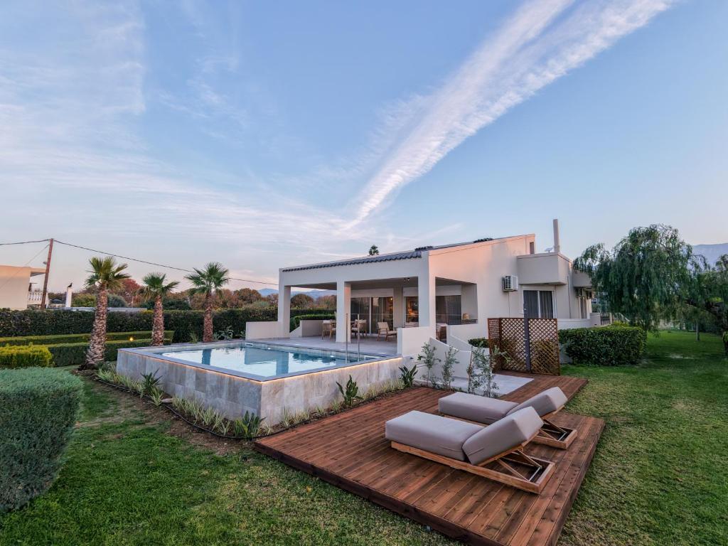 a villa with a swimming pool in a yard at Villa Alaya in Kos