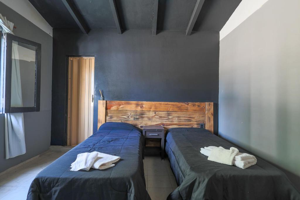 En eller flere senge i et værelse på AUREA HOTELES - Villa Carlos Paz