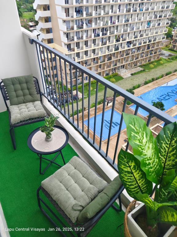 a balcony with two chairs and a table and a building at Miestee Humble abode 1101 in Lapu Lapu City