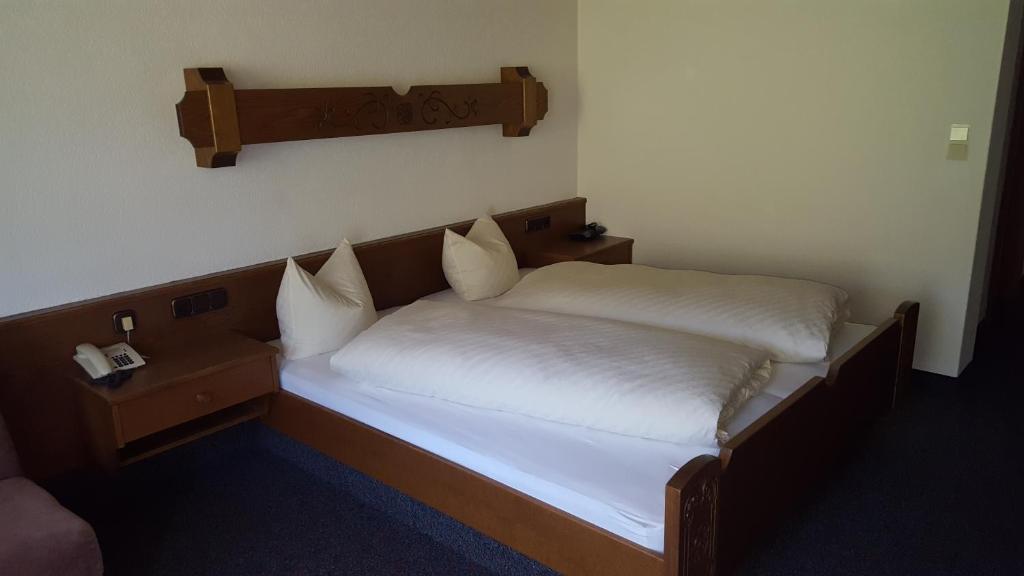 Postel nebo postele na pokoji v ubytování Hotel Garni