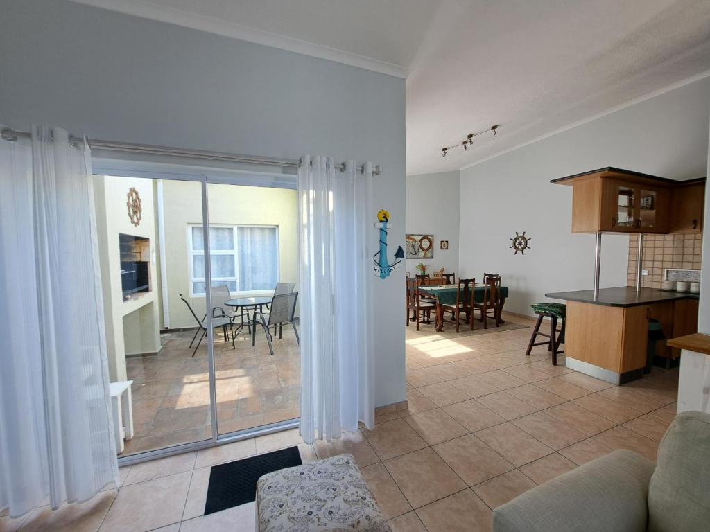 a living room with a kitchen and a dining room at Das Moven Haus in Swakopmund