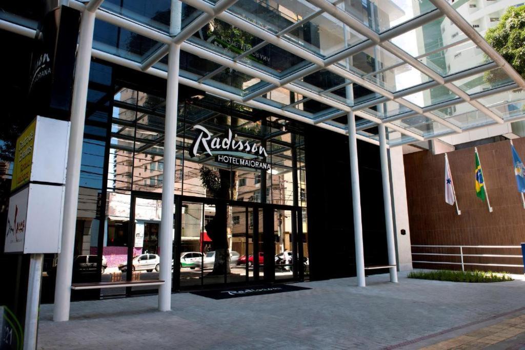 a facade of a building with a sign on it at Flat Radisson Hotel Belem in Belém
