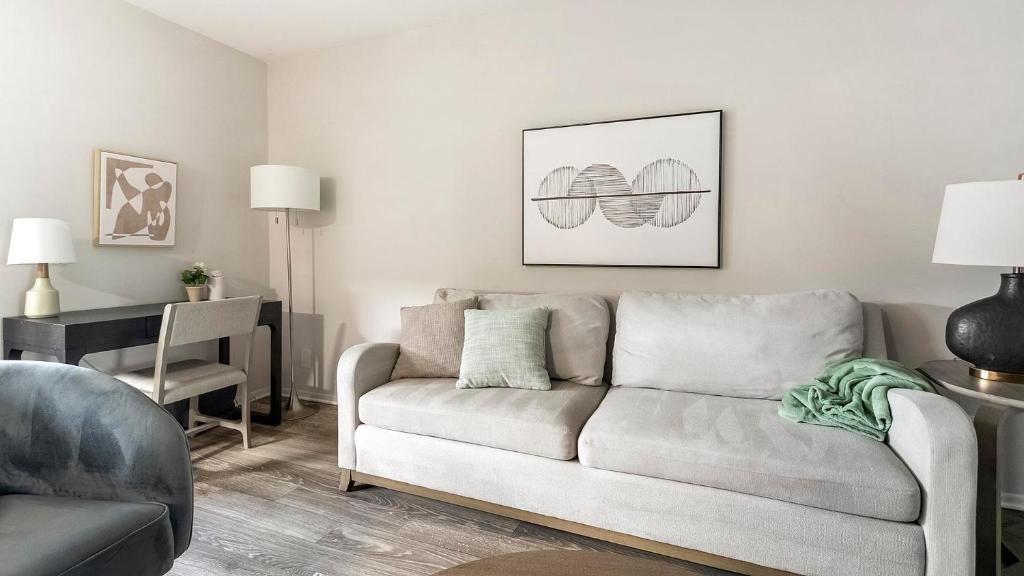 a living room with a couch and a table at Landing Apartments - The Carlisle at Dunedin in Dunedin
