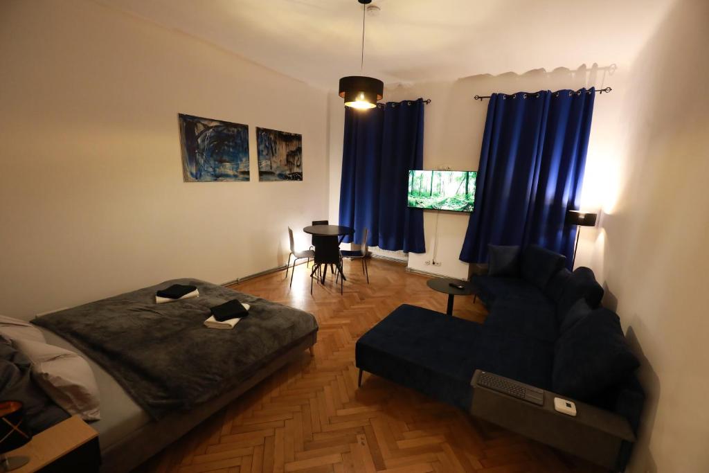 a bedroom with a bed and a couch and a table at Naschpark Dream Apartments! in Vienna