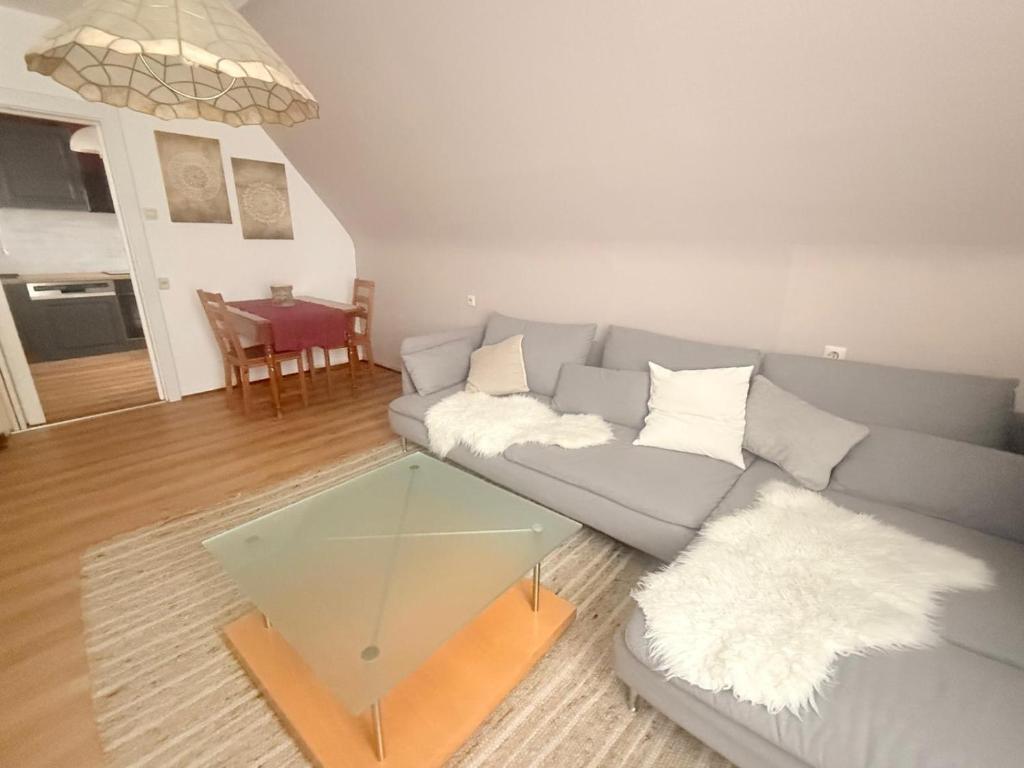 a living room with a couch and a glass table at SeeNah in Niederdorla