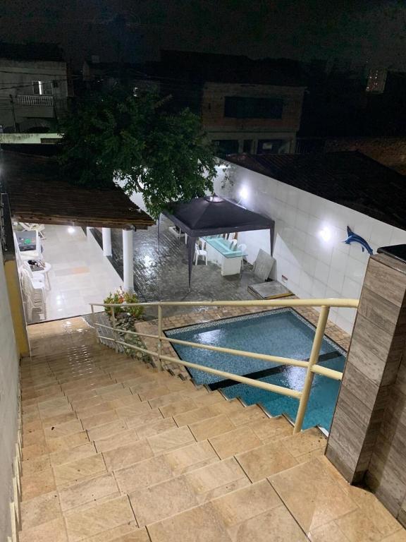 an outdoor swimming pool at night with a pavilion at Beach House in Barra dos Coqueiros