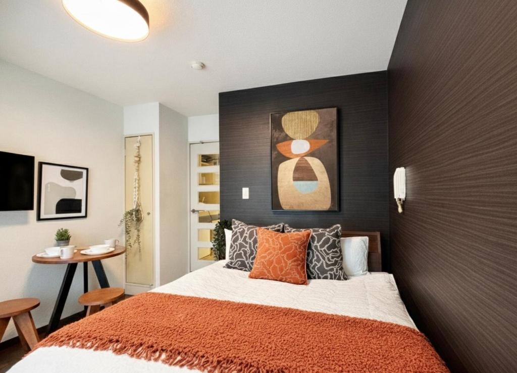 En eller flere senge i et værelse på Hachioji House 201 Apartment