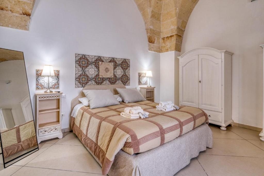 a bedroom with a large bed with two towels on it at Volta Apartment in Mesagne