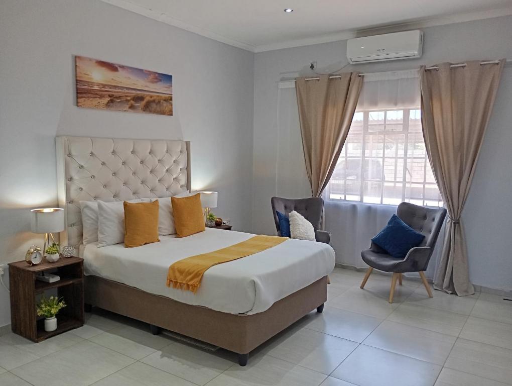 a bedroom with a large bed and a window at Travellers paradise in Palatswe