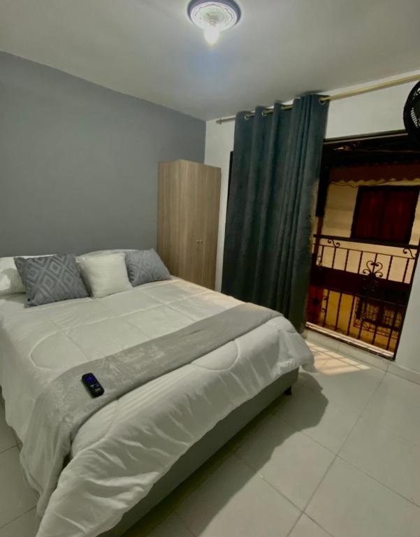 a bedroom with a large bed with a window at Apartamentos con aire acondicionado SAN LUIS in San Luis