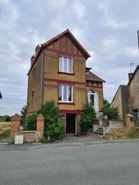 a brick house on the side of a street at Maison Huitlala in Lavaufranche