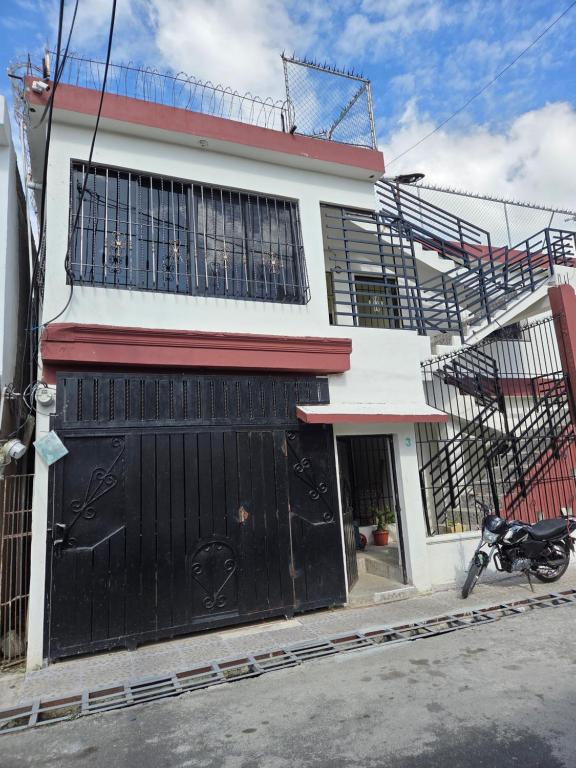 a motorcycle parked in front of a house at Eastern Breeze in Hainamosa