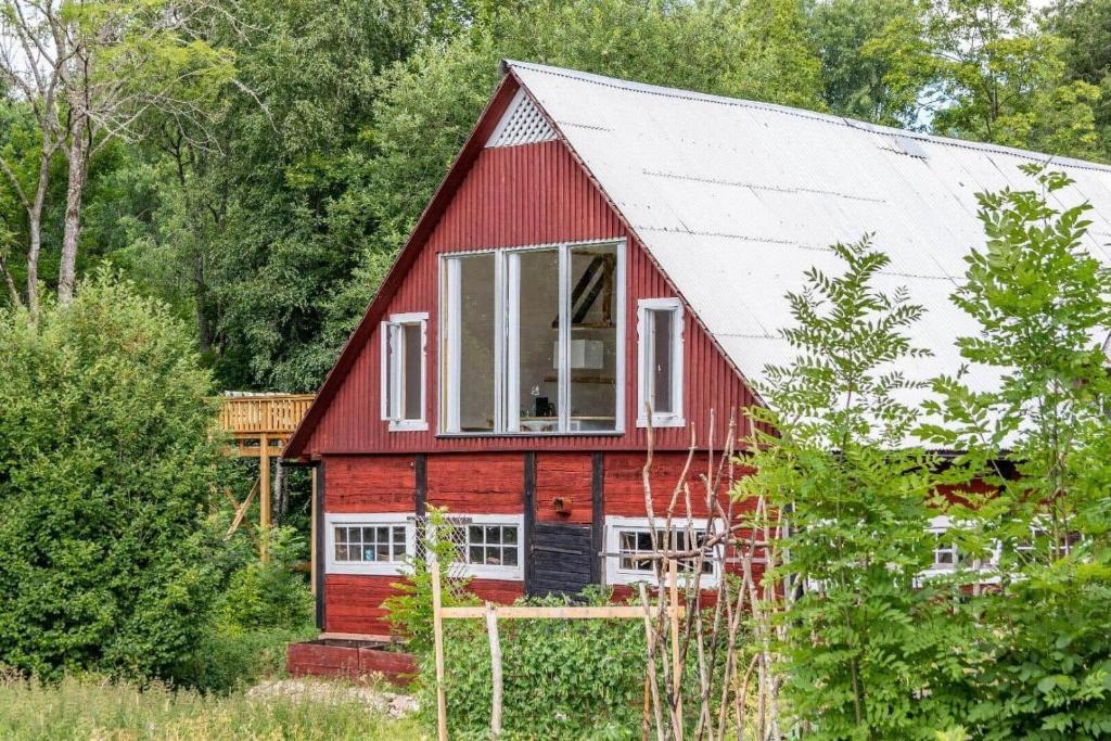 a red barn with a white roof at KRO845-Lessebo-Vedamala-14 in Ljuder