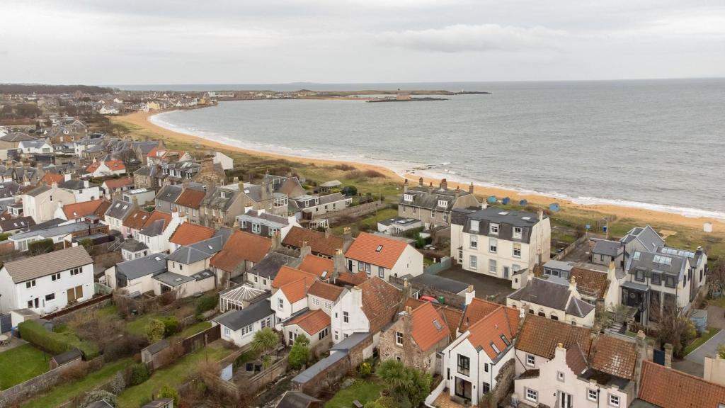 an aerial view of a town next to the ocean at St Albans Lower - Elie in Earlsferry