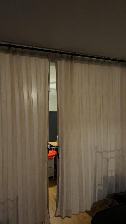 a room with white curtains and a desk at Only 20 a night-Special offer-Man's Bed in Texas City