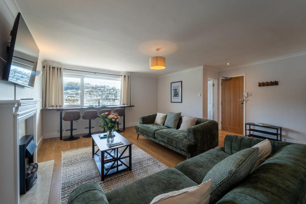 a living room with a couch and a table at Mayflower Penthouse in Dartmouth