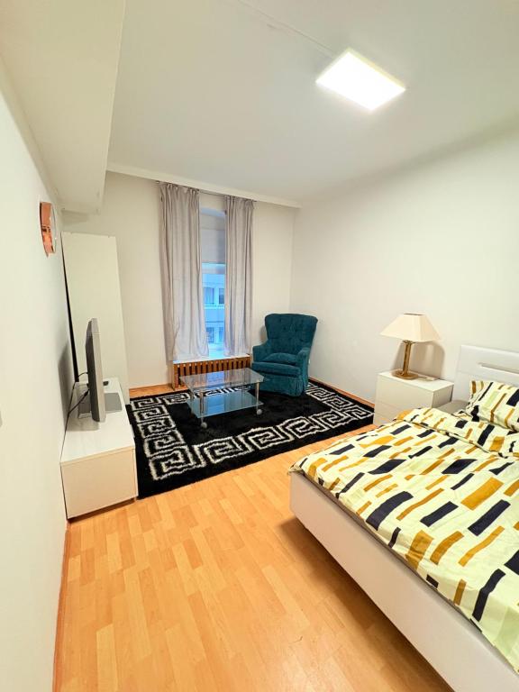 a bedroom with a bed and a chair and a window at Beenie 19 in Linz