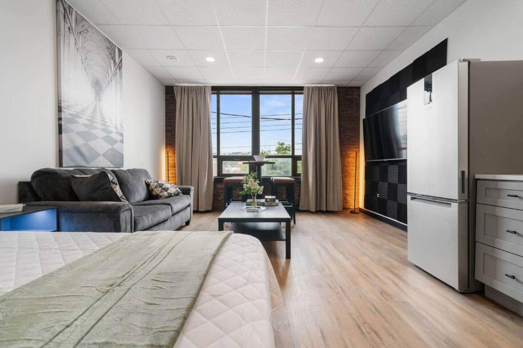 a living room with a bed and a couch at Game Night @ The MillRows Suites in New Glasgow