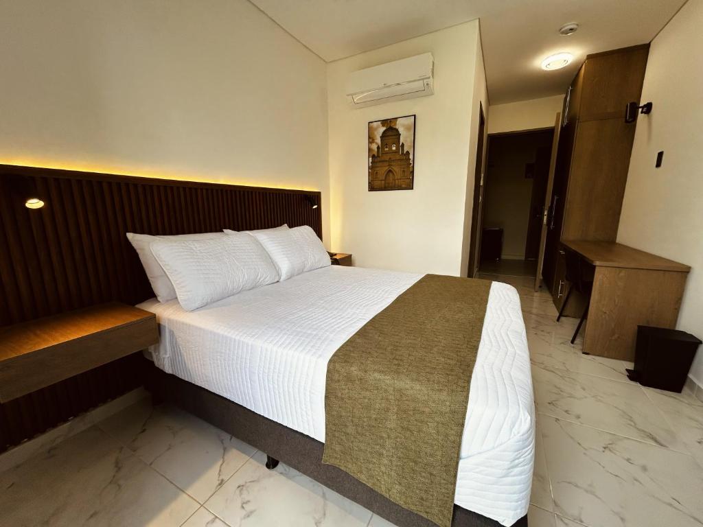 En eller flere senge i et værelse på Hotel Casa Volga