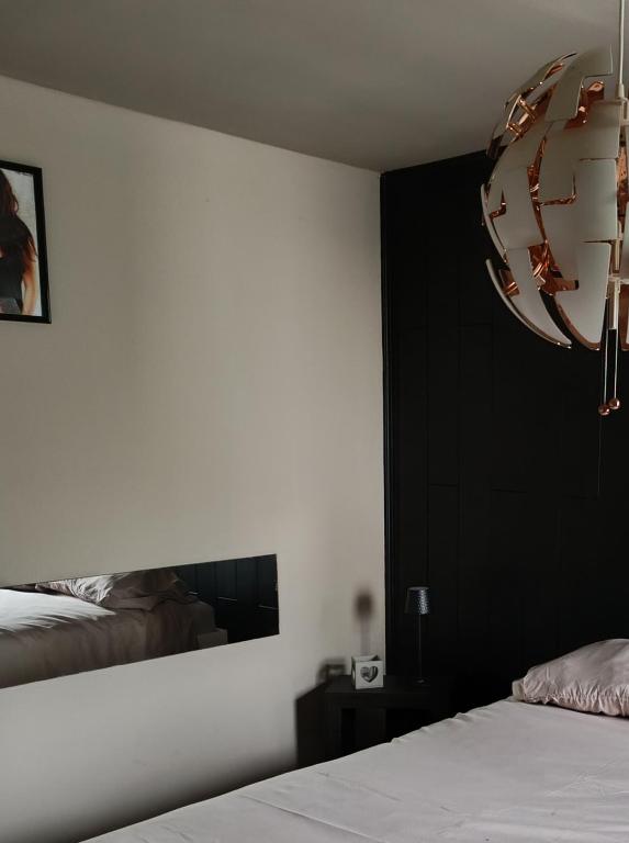 a bedroom with a bed and a mirror on the wall at Lonzee in Gembloux