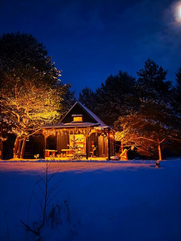 a house is lit up at night with lights at Skujiņa in Princmuiza