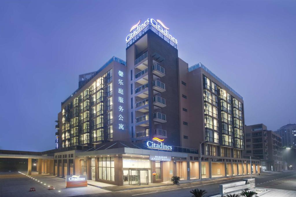 a building with a sign on top of it at Citadines Zhuankou Wuhan in Wuhan