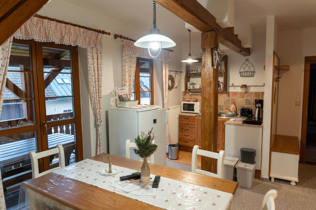 una cucina e una sala da pranzo con tavolo e sedie di Farma Basarovi a Prosečné