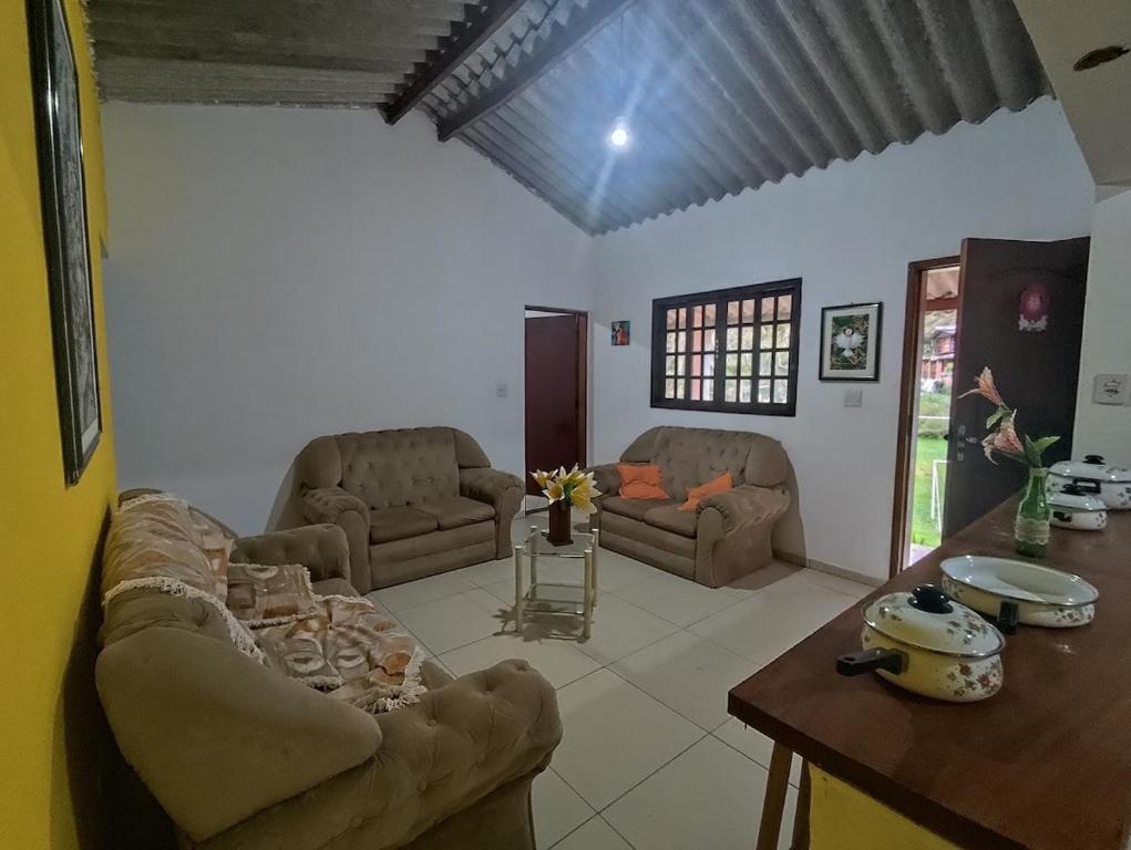 een woonkamer met een bank en een tafel bij Chácara da Vó na Natureza in Mogi das Cruzes