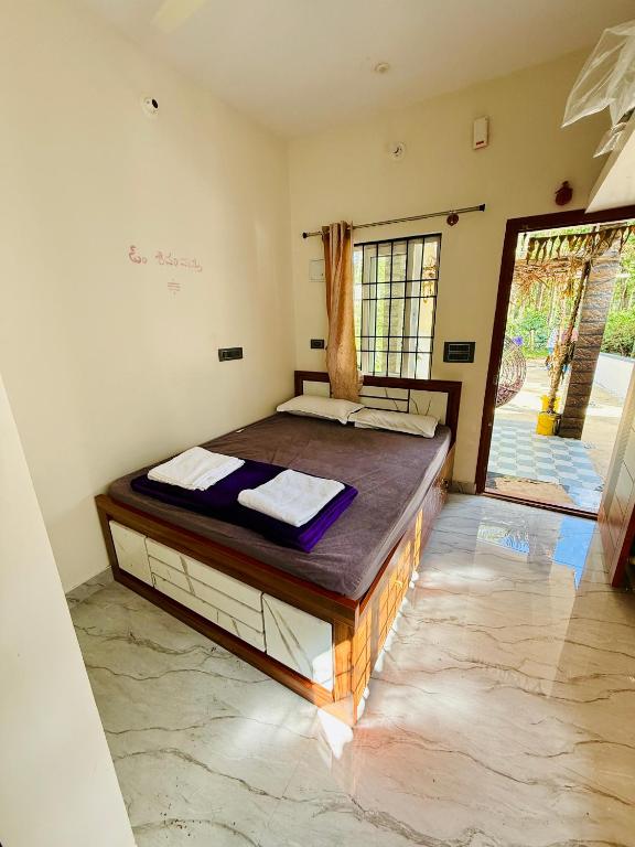 a bedroom with a large bed in a room at Sanju Homestay in Chikmagalūr