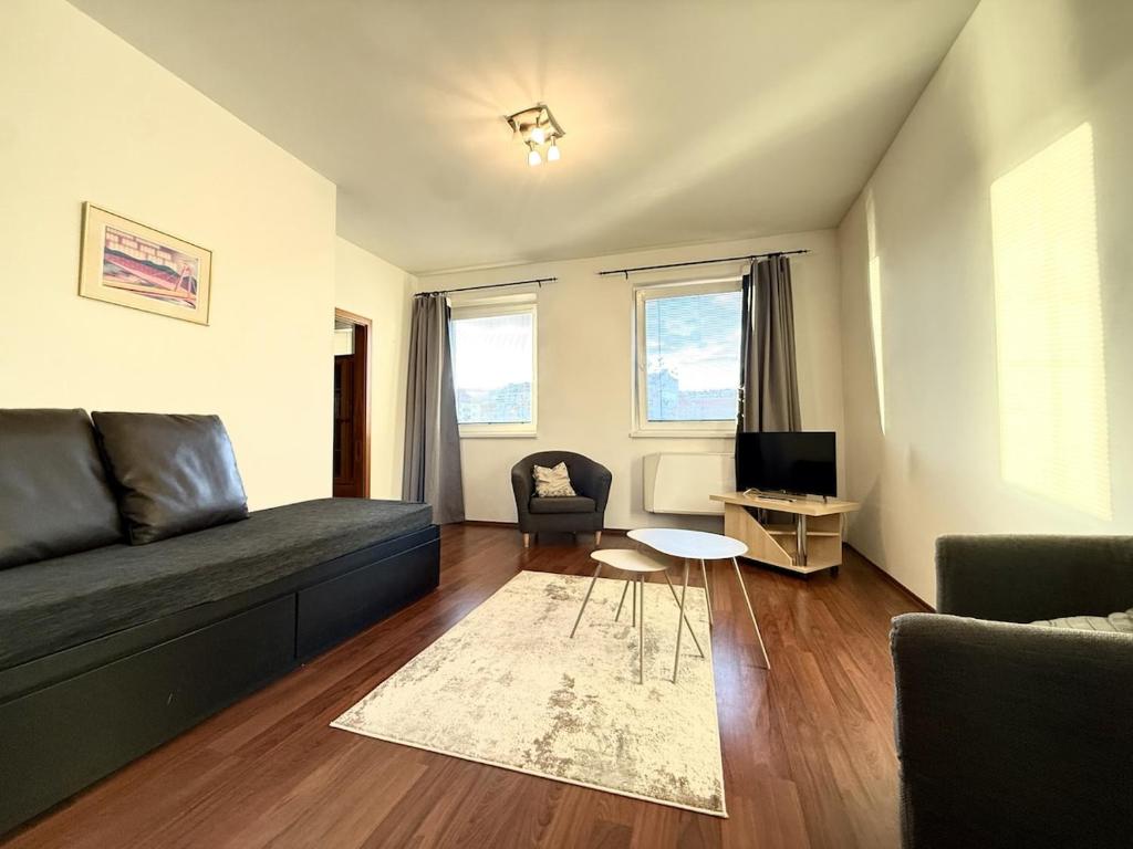 a living room with a couch and a table at Kukucinova Apartments in Bratislava