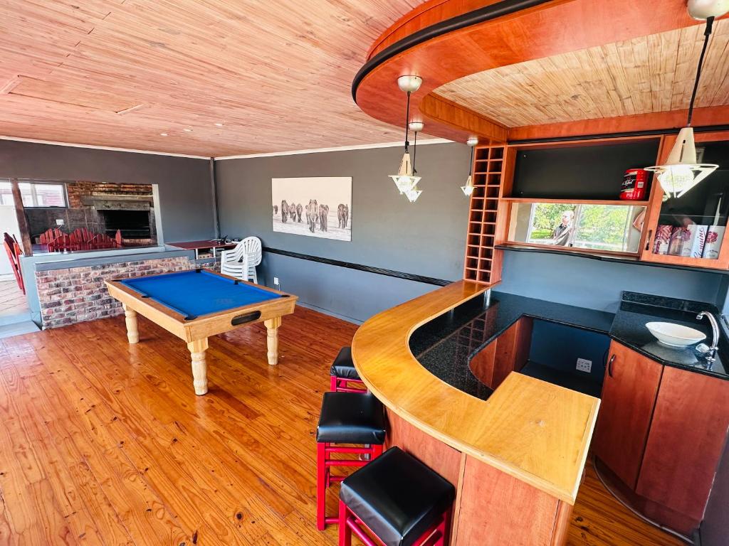 a kitchen with a ping pong table and a bar at Adventure House - Colchester - 5km from Elephant Park in Colchester