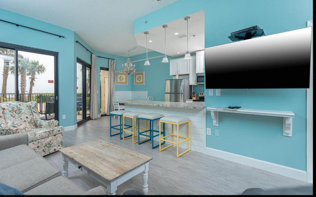 a kitchen and living room with a couch and a table at Phoenix East 002 in Orange Beach