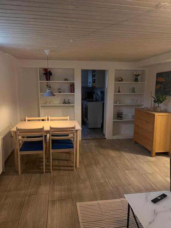 a dining room and living room with a table and chairs at Cozy Corner in Augustenborg
