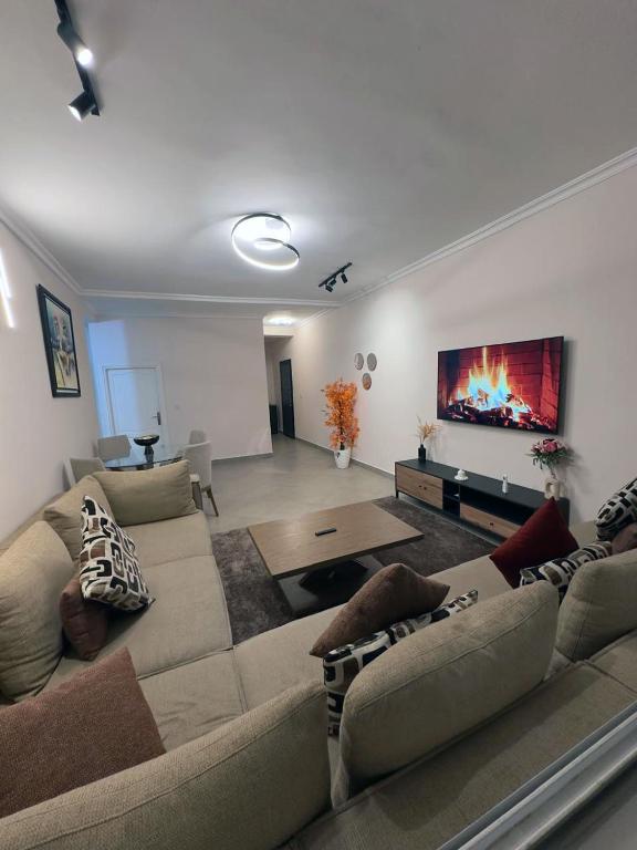 a living room with a couch and a fireplace at Relaxing Apartment Near the Beach Malabata Tanger in Tangier