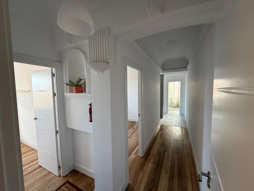 an empty hallway with white walls and wood floors at Gran Bilbao LaGa Apartamentos in Basauri