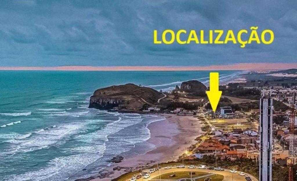 an aerial view of a beach with a yellow arrow at Pé na areia 5 in Torres