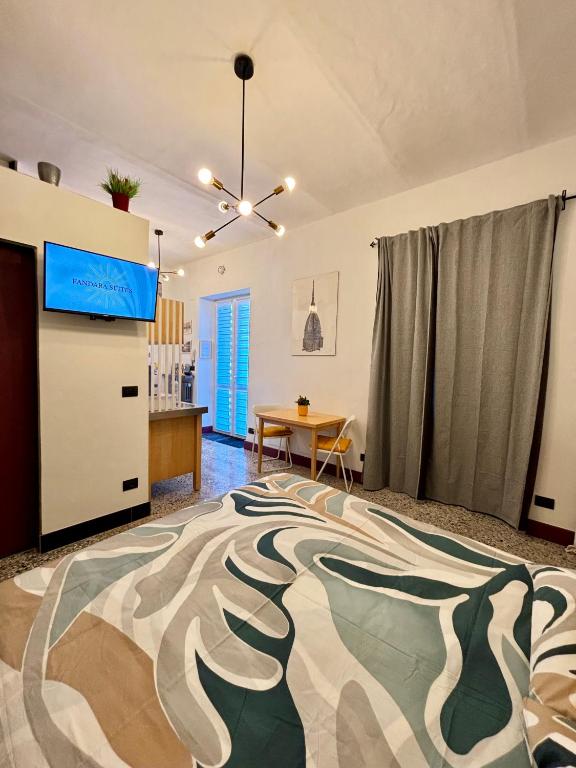 a living room with a bed and a table at Fandara Suites in Turin