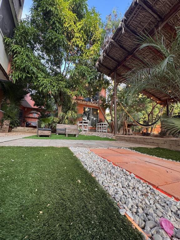 a garden with a stone walkway next to a house at Casa Nawara in Puerto Escondido
