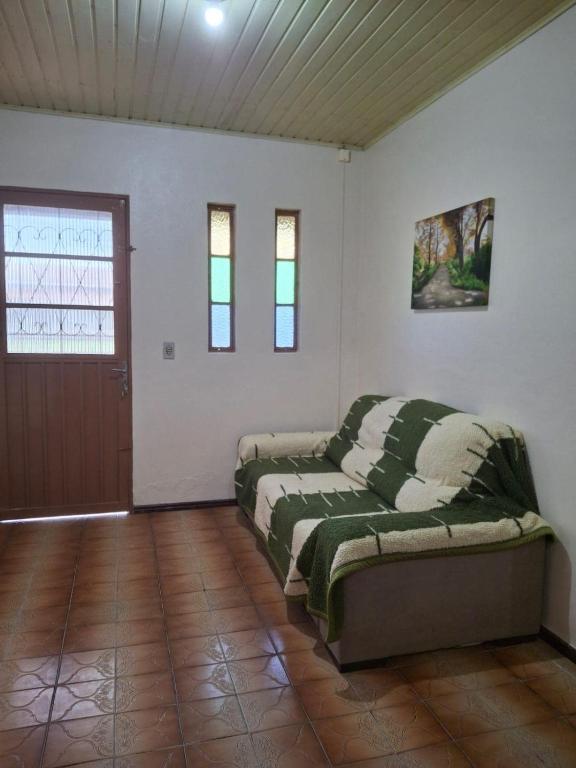 a room with two beds and a door in it at Casa Hermosa in São Gabriel