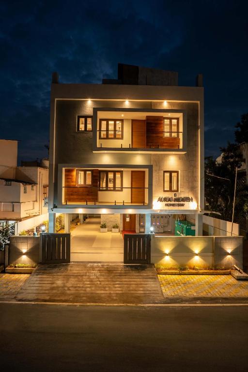 a large house with lights in front of it at night at Aura Heaven in Thanjāvūr