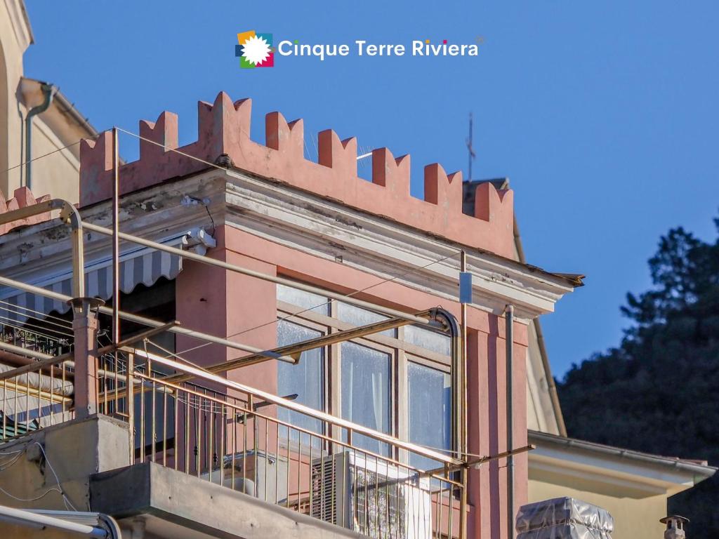 a building with a fence on the side of it at La Torretta dei Merli Studio with Unique Views in Vernazza